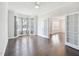 Spacious living room featuring bay windows, glass doors, and hardwood floors at 514 Bonville Ct, Fuquay Varina, NC 27526