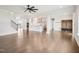 Open-concept living area with hardwood floors, kitchen view, and bright natural light at 514 Bonville Ct, Fuquay Varina, NC 27526