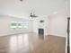 Open-concept living room featuring fireplace, hardwood floors, ceiling fan, and great light at 514 Bonville Ct, Fuquay Varina, NC 27526