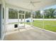A screened-in porch features an umbrella and concrete flooring at 514 Bonville Ct, Fuquay Varina, NC 27526