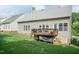 Exterior view of the backyard showing the deck, siding, and lush lawn at 5501 Southern Cross Ave, Raleigh, NC 27606