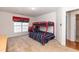 bedroom with a colorful red and blue bunk bed and a cozy chair at 5501 Southern Cross Ave, Raleigh, NC 27606