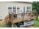 Back deck features chairs and a grill, with stairs leading down to the backyard at 5501 Southern Cross Ave, Raleigh, NC 27606