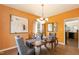 Dining room featuring hardwood floors, ample lighting, and an adjacent room at 5501 Southern Cross Ave, Raleigh, NC 27606