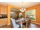 Cozy dining room with hardwood floors, chandelier, and a view into the kitchen at 5501 Southern Cross Ave, Raleigh, NC 27606