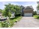 Charming two-story home featuring an attached garage, driveway, and well-manicured front yard at 5501 Southern Cross Ave, Raleigh, NC 27606