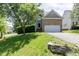 Charming brick home featuring a well-manicured lawn and attached two car garage at 5501 Southern Cross Ave, Raleigh, NC 27606