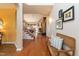 Inviting foyer with hardwood floors, a staircase, and a comfortable bench at 5501 Southern Cross Ave, Raleigh, NC 27606