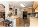 Kitchen island with seating, appliances, and a view of the upstairs and living area at 5501 Southern Cross Ave, Raleigh, NC 27606