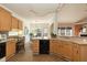 Kitchen area with a breakfast bar, tile flooring, and wooden cabinets; dining area visible at 5501 Southern Cross Ave, Raleigh, NC 27606