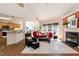 Open concept living room with fireplace, bar seating, and large windows at 5501 Southern Cross Ave, Raleigh, NC 27606