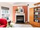 Inviting living room with a fireplace, modern decor, and a built-in wooden cabinet at 5501 Southern Cross Ave, Raleigh, NC 27606