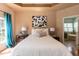 Main bedroom with hardwood floors, a king bed, and an ensuite bathroom with a soaking tub at 5501 Southern Cross Ave, Raleigh, NC 27606