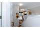 View of the stairway leading to a landing with views of the living and dining area at 5501 Southern Cross Ave, Raleigh, NC 27606