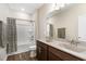 A bathroom features a shower and double sinks, providing ample space and modern convenience at 59 White Quartz Pl, Fuquay Varina, NC 27526