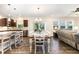 Open concept dining room flows into kitchen, featuring modern chandelier and ample seating at 59 White Quartz Pl, Fuquay Varina, NC 27526