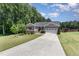 Inviting single-story home with a manicured front yard and driveway leading to a two-car garage at 59 White Quartz Pl, Fuquay Varina, NC 27526