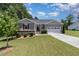 Charming single-story home with a well-manicured lawn, attached garage, and inviting curb appeal at 59 White Quartz Pl, Fuquay Varina, NC 27526