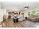 Expansive open-concept living area with natural light, stylish decor, and seamless flow to kitchen and dining at 59 White Quartz Pl, Fuquay Varina, NC 27526