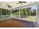 Relaxing screened porch with ceiling fans and views of the wooded backyard, perfect for outdoor enjoyment at 59 White Quartz Pl, Fuquay Varina, NC 27526