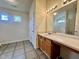 Bright bathroom featuring neutral tile floors and a vanity with storage space at 5911 Endsley Ct, Raleigh, NC 27610