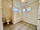 Bright bathroom featuring neutral tile floors and a combination tub and shower at 5911 Endsley Ct, Raleigh, NC 27610
