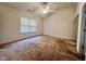 Large carpeted bedroom with a ceiling fan and a window for natural light at 5911 Endsley Ct, Raleigh, NC 27610