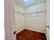 Walk-in closet with built-in wire shelving and wood-look flooring at 5911 Endsley Ct, Raleigh, NC 27610