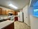 A kitchen featuring oak cabinets, a gas stove, and a white refrigerator at 5911 Endsley Ct, Raleigh, NC 27610