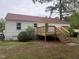 Rear view of home featuring wood deck and private backyard at 6300 Nc 27, Coats, NC 27521