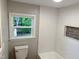 Clean bathroom featuring subway tile walls, modern fixtures, and a window view at 6300 Nc 27, Coats, NC 27521