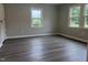 This bedroom features gray walls, updated flooring and trim and two windows offering plenty of natural light at 6300 Nc 27, Coats, NC 27521