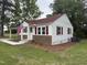 Well-maintained home with vinyl siding, brick accents, and a manicured front yard at 6300 Nc 27, Coats, NC 27521