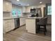 Bright kitchen with stainless steel appliances, granite countertops, and central island at 6300 Nc 27, Coats, NC 27521