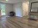 A spacious living room is shown, with fresh paint and updated flooring at 6300 Nc 27, Coats, NC 27521