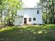Back of house showcasing large yard, back door and windows of the house at 8 Woodsprite Ct, Durham, NC 27703