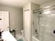 Full bathroom with a glass-enclosed shower over tub, white toilet, and updated fixtures for a fresh, clean feel at 8 Woodsprite Ct, Durham, NC 27703