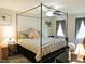 A beautifully appointed bedroom boasts a four-poster bed and natural light at 8 Woodsprite Ct, Durham, NC 27703