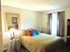 Cozy bedroom with earth-toned bedding, colorful accent pillows, and ample natural light from the nearby window at 8 Woodsprite Ct, Durham, NC 27703