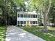 Charming two-story home with black shutters, a bright yellow door, and a well-manicured lawn at 8 Woodsprite Ct, Durham, NC 27703