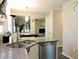 Open kitchen view highlighting granite countertops, a stainless steel sink, and modern cabinetry at 8 Woodsprite Ct, Durham, NC 27703
