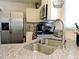 The kitchen features white cabinets, a stainless steel refrigerator, and granite countertops at 8 Woodsprite Ct, Durham, NC 27703