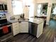 Kitchen boasts stainless appliances, gray flooring, and granite countertops with an eat-in area at 8 Woodsprite Ct, Durham, NC 27703