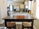 Kitchen dining area with stainless steel appliances and a granite countertop bar at 8 Woodsprite Ct, Durham, NC 27703