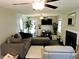 Comfortable living room area boasts lots of seating, dark wood floors and a tiled fireplace at 8 Woodsprite Ct, Durham, NC 27703