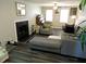 Inviting living room showcasing a gray sectional, tiled fireplace, and hardwood floors at 8 Woodsprite Ct, Durham, NC 27703