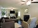 Cozy living room features dark wood floors, modern furniture, fireplace and multiple ceiling fans at 8 Woodsprite Ct, Durham, NC 27703