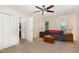 Bonus room with gray sofa, lamps, wood trunk table, ceiling fan, and closet access to ensuite bathroom at 809 Maple Shade Ln, Apex, NC 27502