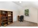 The room has neutral paint, carpet flooring, a window, and a bookshelf at 809 Maple Shade Ln, Apex, NC 27502