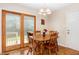 Cozy dining area features wood table, chairs, and sliding glass doors to the exterior at 809 Maple Shade Ln, Apex, NC 27502